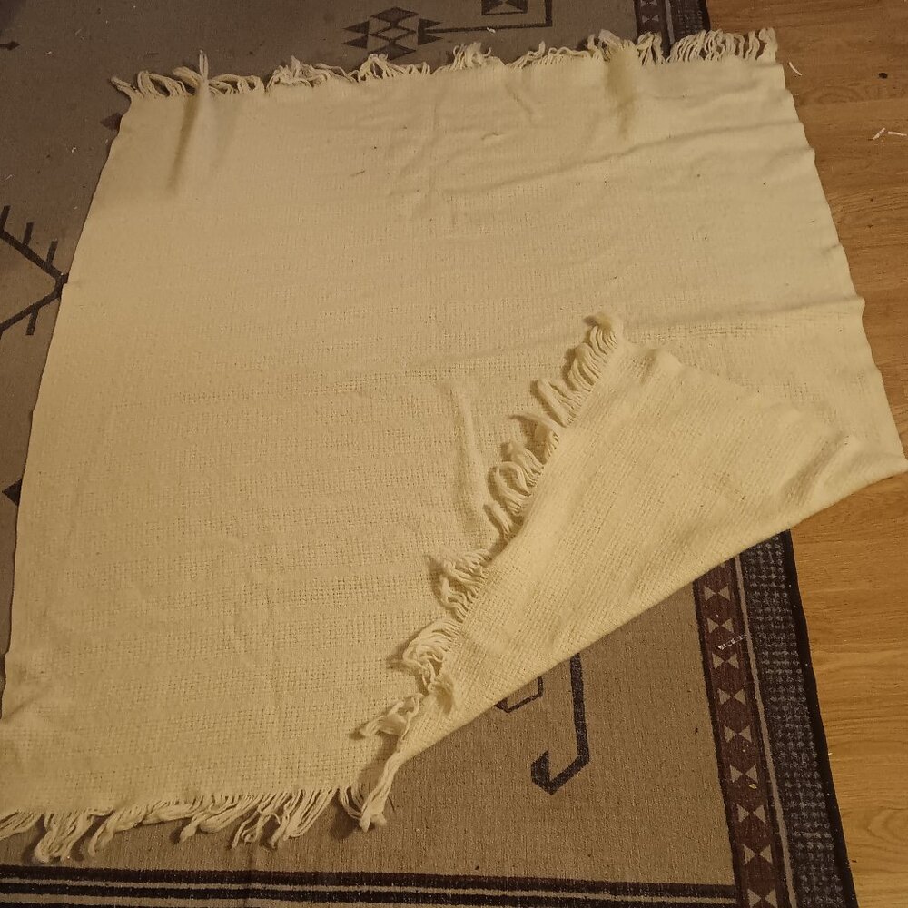 Faribo cream knitted throw. Wool & acrylic blend. Machine washable.